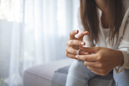 woman holding wedding ring