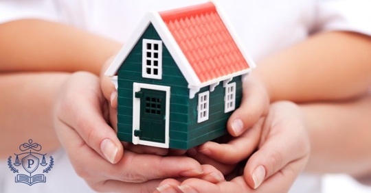 parent and child with house figurine